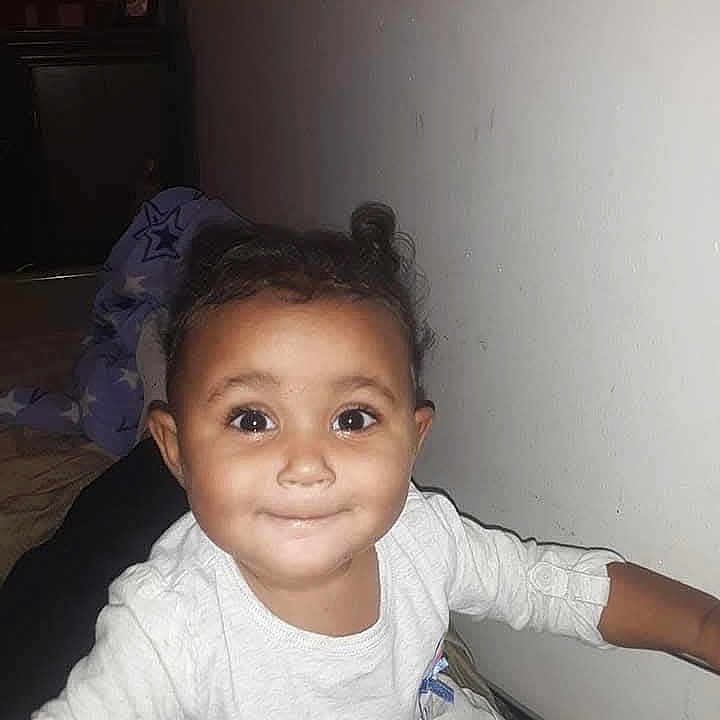 Amazin Miller joined the competition — help win amazing prizes! baby, bed, blanket, child, cozy, curly_hair, cute, expression, face, hand, happy, indoor, person, portrait, smiling, star_pattern, toddler, wall, white_clothing, young_child