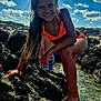 child, girl, bikini, rocks, water, beach, sunny, smiling, outdoor, sky, clouds, summer, vacation, playful, nature, barefoot, happy, portrait, sunlight, holiday
