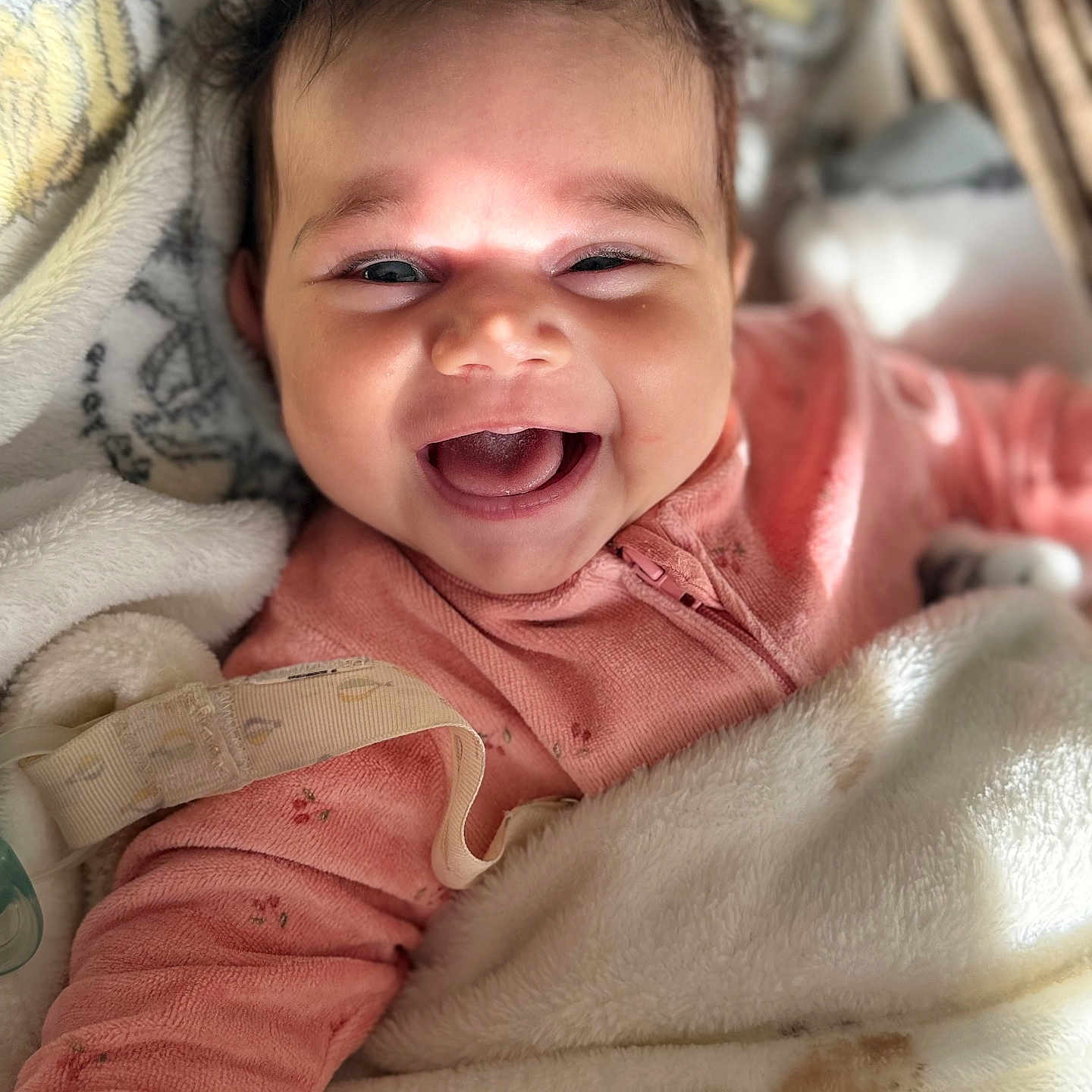 Taliah joined the competition — help win amazing prizes! adorable, baby, blanket, child, closeup, cozy, cute, expression, face, happy, indoors, infant, joy, pink_clothing, portrait, relaxed, sleepwear, smiling, soft, warm