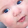 baby, close_up, face, blue_eyes, skin, smile, teeth, infant, child, cute, soft_skin, apparel, fabric, texture, strap, portrait, young, expression, head, eyelashes