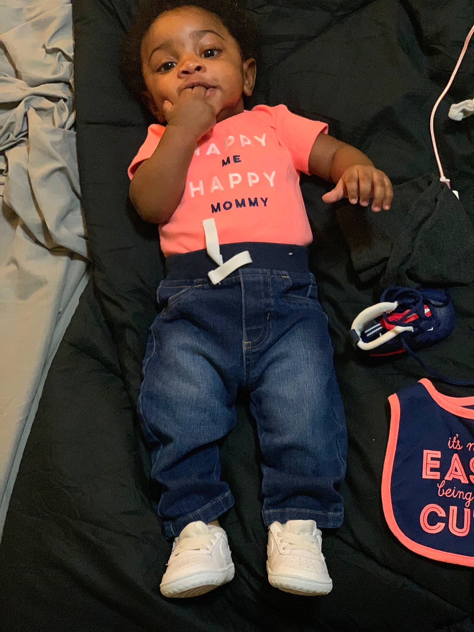 Montez is registered to the contest to win money with this photo: baby_toddler_clothing, bag, carmine, child, comfort, cool, denim, elbow, flash_photography, fun, gesture, happy, person, room, sitting, sleeve, t_shirt, thumb, toddler, top