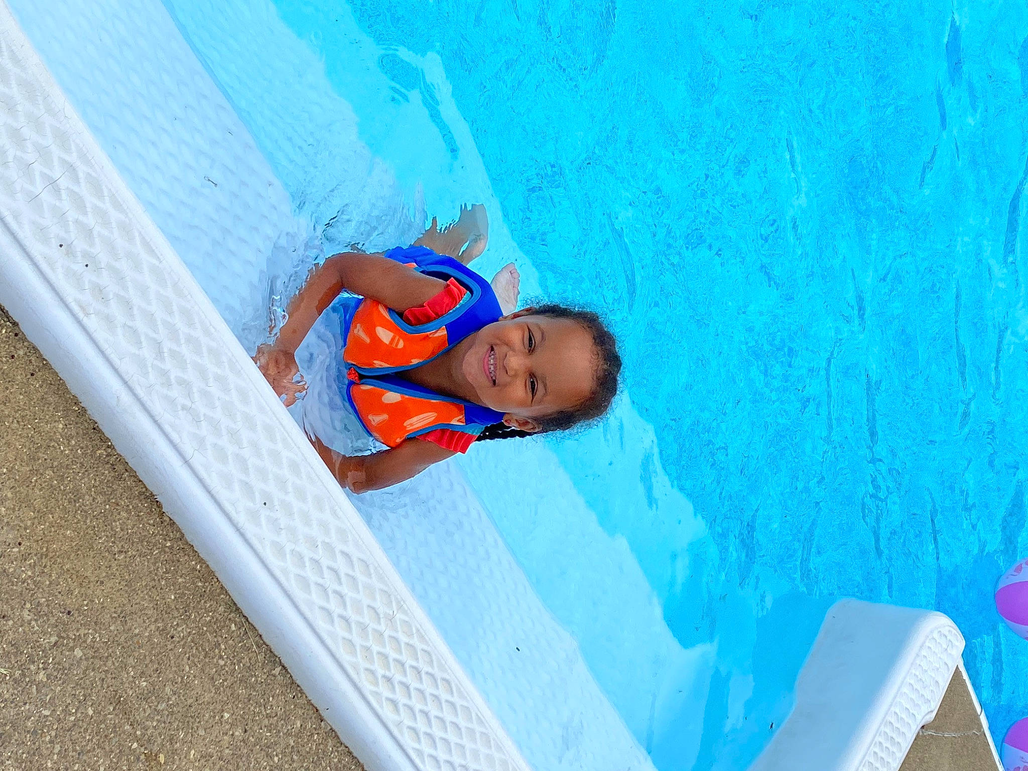Jordyn is registered to the contest to win money with this photo: azure, blue, child, chute, electric_blue, font, fun, joy, leisure, paint, person, plastic, recreation, slope, smile, swimming_pool, toddler, vacation, water