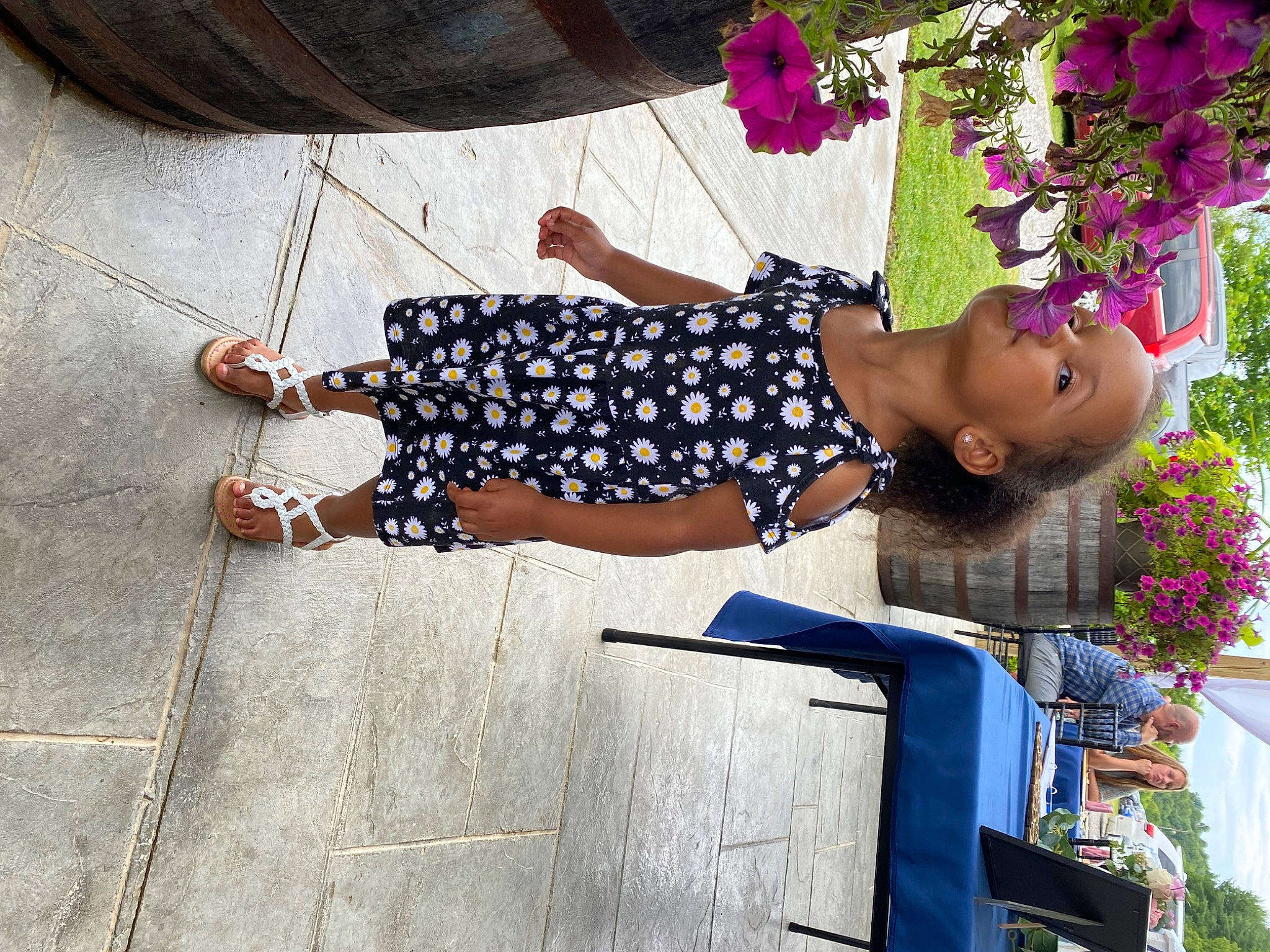 Jordyn is registered to the contest to win money with this photo: child, denim, dress, electric_blue, flooring, flower, foot, fun, happy, human_leg, leisure, magenta, pattern, person, petal, plant, road_surface, sandal, sunglasses, thigh