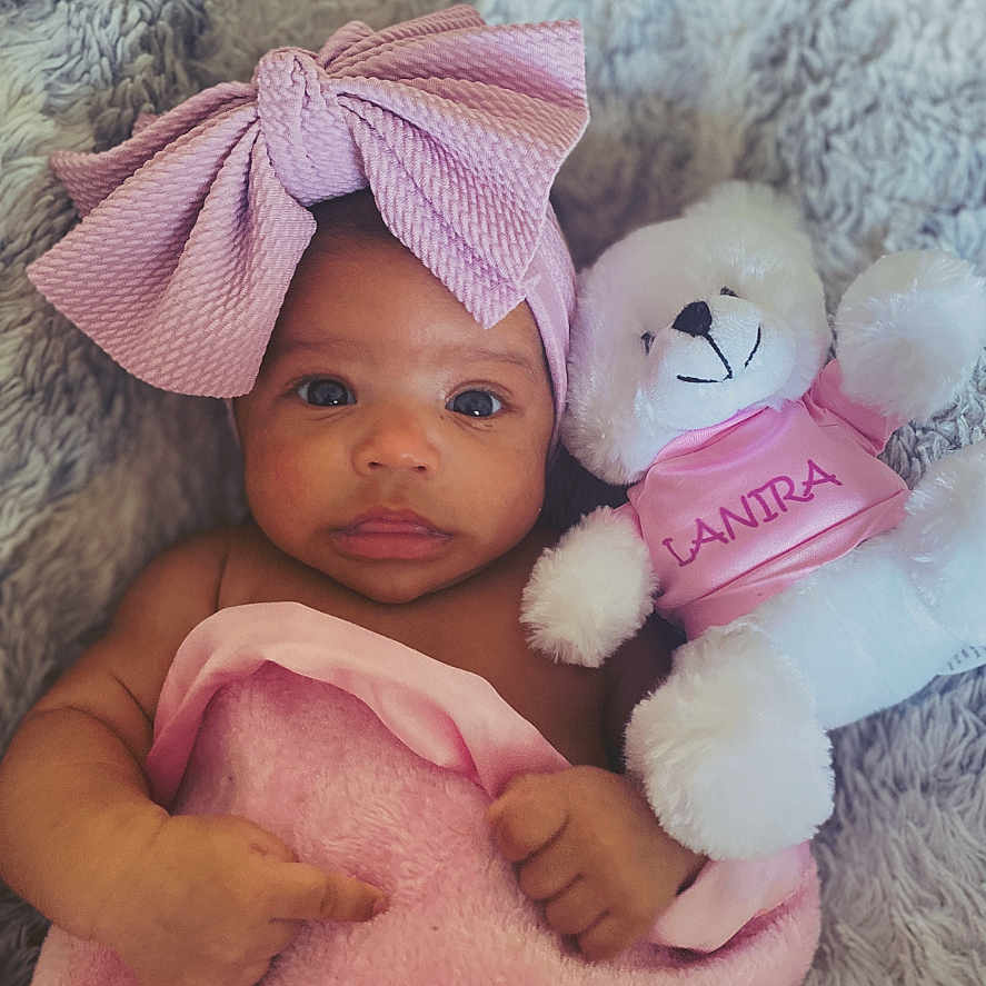 Lanira is registered to the contest to win money with this photo: baby, blanket, bodypart, bonnet, cap, clothing, face, finger, hand, happy, hat, head, newborn, person, photography, portrait, sleeping, smile, teddybear, toy