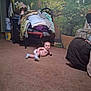 Sky is registered to the contest to win money with this photo: baby, indoor, carpet, diaper, socks, chair, blankets, clothes, plant, mural, floor, curious, child, home, living_room, furniture, potted_plant, person, casual, cozy