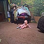 baby, carpet, indoor, chair, blanket, plant, pillow, floor, smiling, child, cozy, home, furniture, socks, room, decor, pot, clock, door, bucket