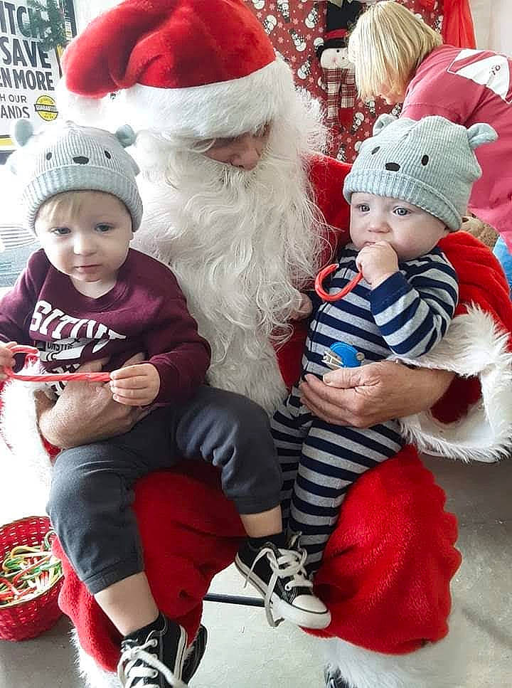 Alexander is registered to the contest to win money with this photo: baby, beard, child, christmas, christmas_decoration, christmas_ornament, face, fun, happy, hat, headwear, lap, leg, person, plant, red, santa_claus, shoe, sneakers, toddler