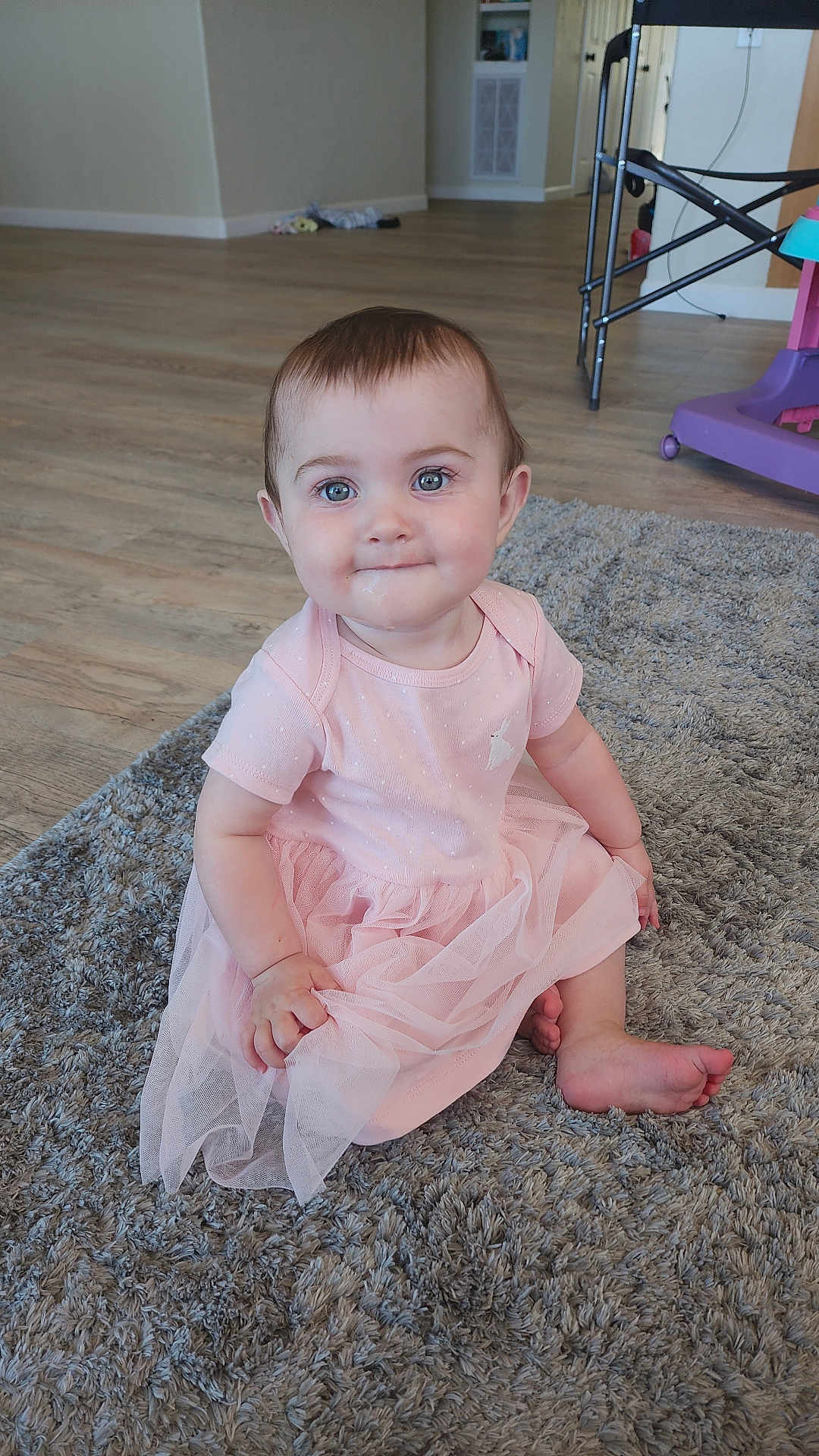 D'Alva joined the competition — help win amazing prizes! baby, child, pink_dress, carpet, floor, indoor, cute, smile, sitting, blue_eyes, person, toddler, soft_lighting, home, furniture, wood_floor, happy, portrait, infant, clothing
