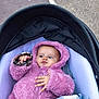 baby, child, stroller, pink_jacket, hood, blanket, outdoor, curious, infant, clothing, cold_weather, cute, young, person, portrait, hand, face, cozy, baby_clothes, baby_accessory
