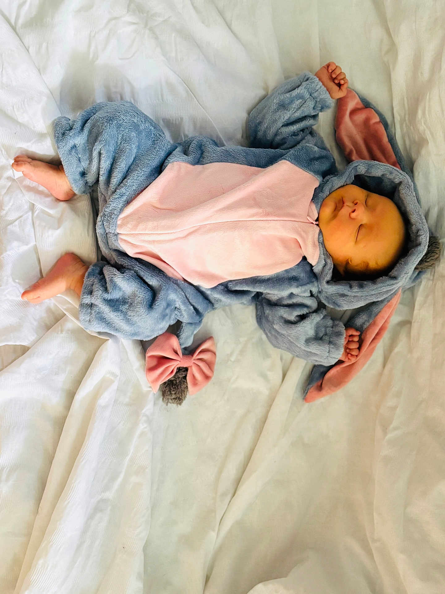 Asher is registered to the contest to win money with this photo: baby, sleeping, costume, bunny_ears, fluffy, blanket, cute, infant, soft, pink, blue, hands, feet, hood, sleep, child, one_person, indoors, resting, adorable