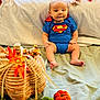 Asher joined the competition — help win amazing prizes! baby, superman_costume, autumn, pumpkins, blanket, basket, fall_leaves, decorations, infant, costume, sitting, indoors, cute, festive, orange, green, soft_lighting, portrait, child, holiday