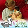 Caspian is registered to the contest to win money with this photo: baby, child, adult, holding, affection, pacifier, red_chair, indoor, love, comfort, cuddle, skin_tone, hair, clothing, person, portrait, cartoon, text_overlay, heart, skunk