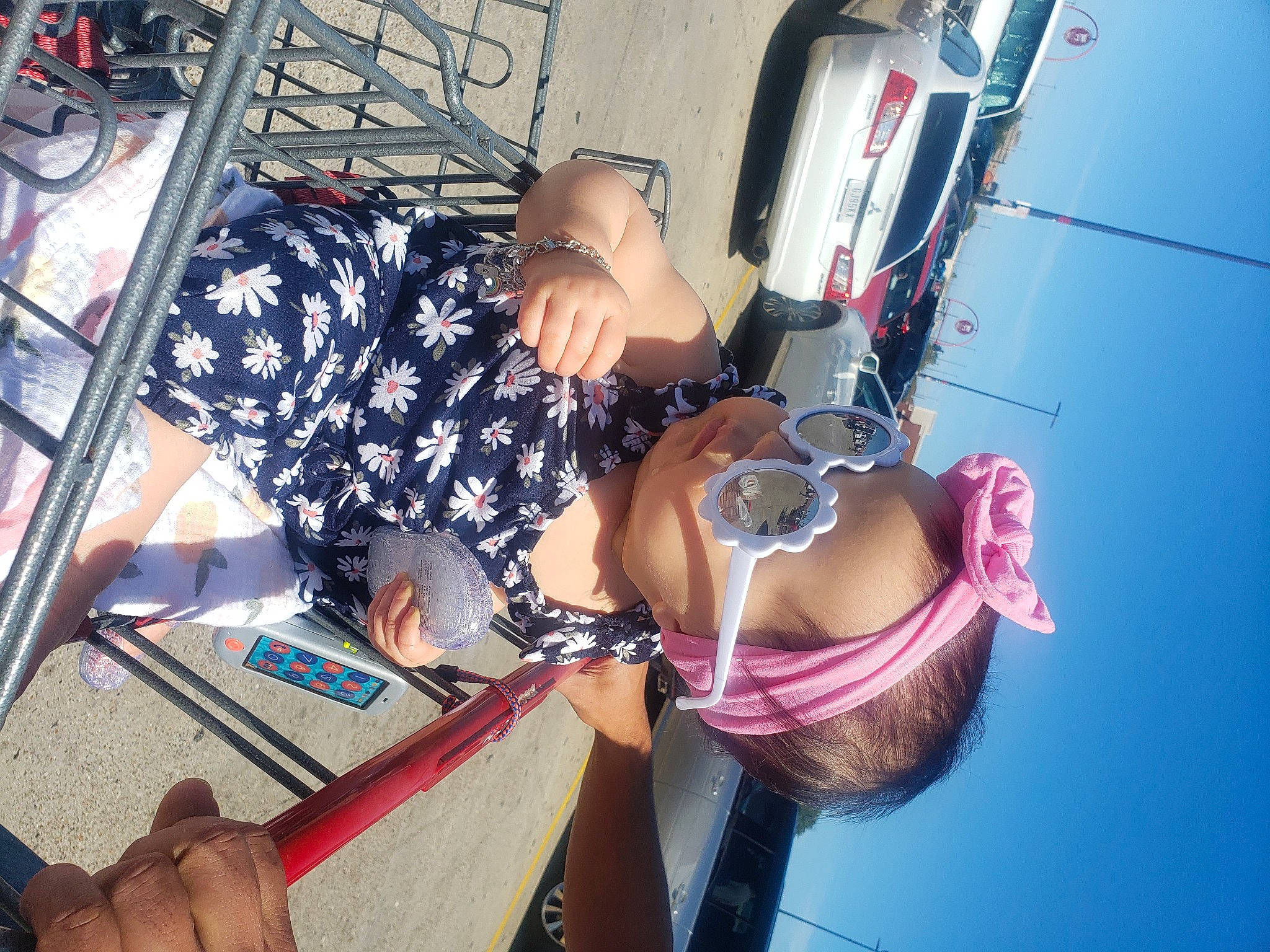 Caroline is registered to the contest to win money with this photo: automotive_exterior, dress, elbow, eyewear, fun, glasses, hand, hat, human_leg, leg, leisure, magenta, motor_vehicle, naval_architecture, person, sky, sunglasses, thigh, vehicle_door