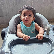 Daniel participe au concours pour gagner de l'argent avec cette photo : toddler, baby, child, walker, toy_car, curly_hair, blue_shirt, indoor, concrete_wall, grip, face, expression, person, seat, hands, plastic, floor, cute, young_child, portrait