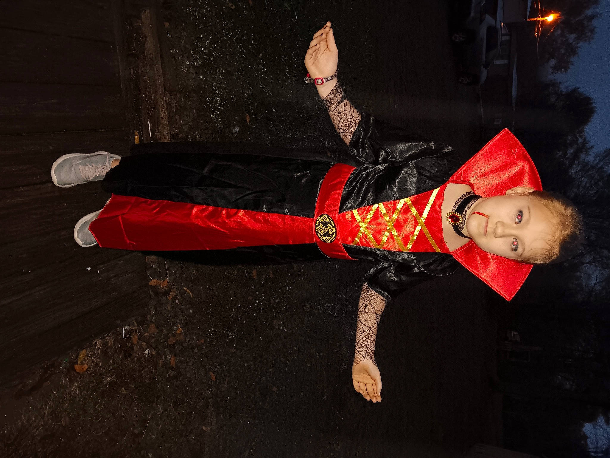 Carolina is registered to the contest to win money with this photo: carmine, costume, darkness, event, flash_photography, fun, gesture, human_leg, midnight, night, person, sleeve, tree