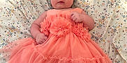 Ivory is registered to the contest to win money with this photo: adorable, baby, barefoot, blanket, bow, child, cute, dress, fabric, floral_pattern, happy, headband, indoor, infant, lying_down, pink, portrait, small_hands, soft, young