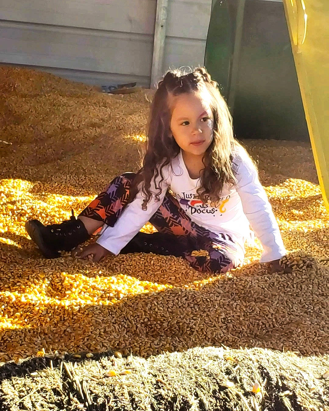 Emry is registered to the contest to win money with this photo: asphalt, blond, brown_hair, child, city, field, flooring, fun, grass, hairstyle, happy, people_in_nature, person, portrait_photography, road_surface, shadow, sitting, soil, tints_and_shades, toddler