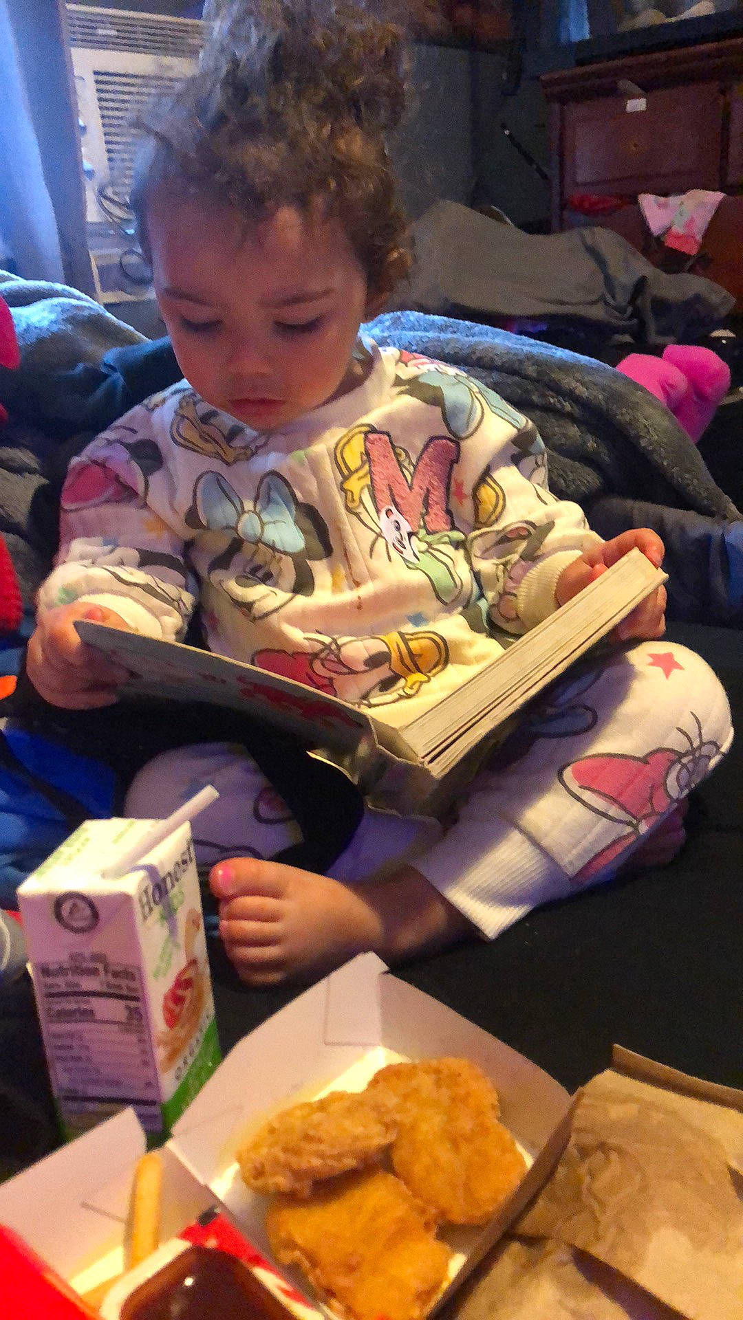 Reyna is registered to the contest to win money with this photo: baby, child, christmas_eve, comfort_food, cuisine, deep_frying, fast_food, finger_food, food, fried_food, holiday, ingredient, junk_food, lap, person, play, publication, reading, sharing, sitting