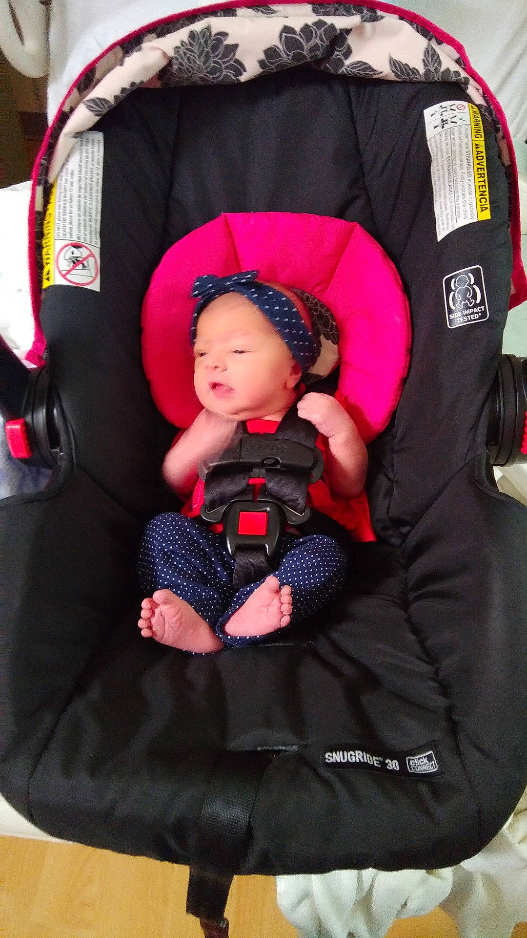 Sandra is registered to the contest to win money with this photo: baby_carriage, baby_products, black, car_seat, child, fun, infant, magenta, person, pink, product, purple, red, textile, toddler