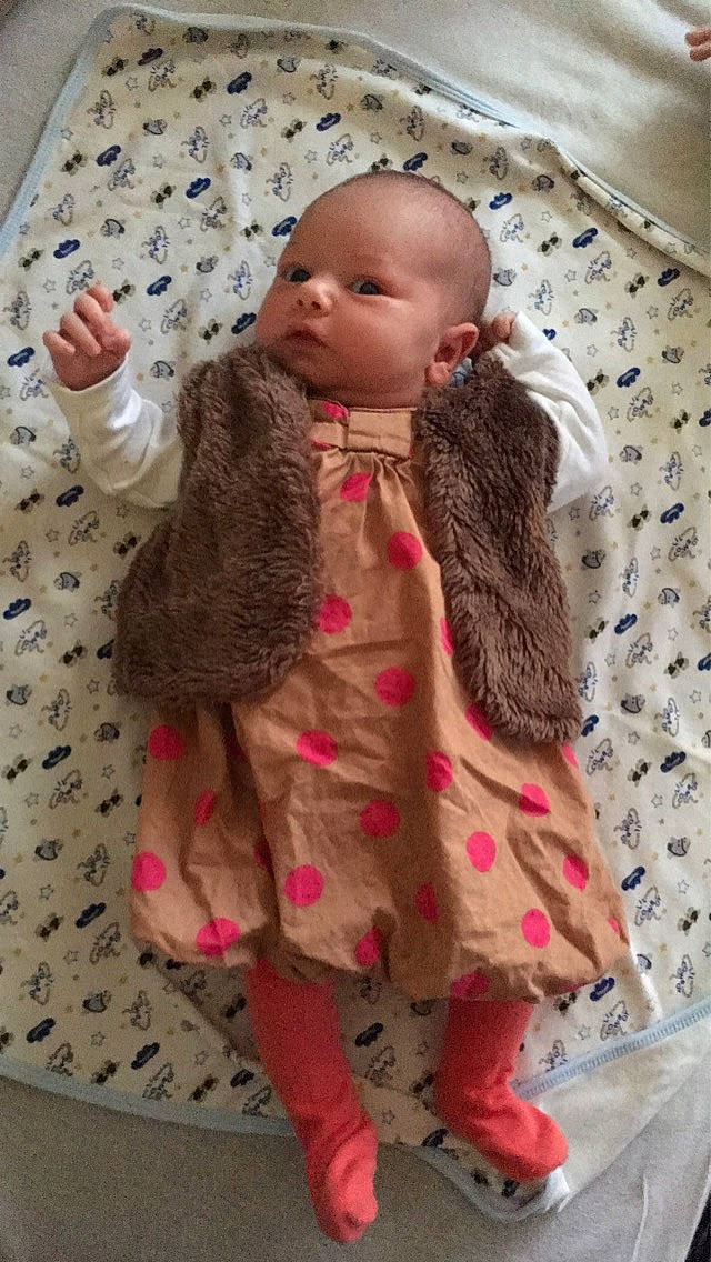 Julya participe au concours pour gagner de l'argent avec cette photo : baby, brown_hair, cheek, child, clothing, doll, outerwear, pattern, person, pink, skin, toddler, toy, wool