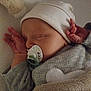 Maylo participe au concours pour gagner de l'argent avec cette photo : baby, sleeping, pacifier, blanket, hat, infant, hand, soft_toy, plush, cozy, cute, child, resting, bed, clothing, newborn, peaceful, indoors, portrait, warm