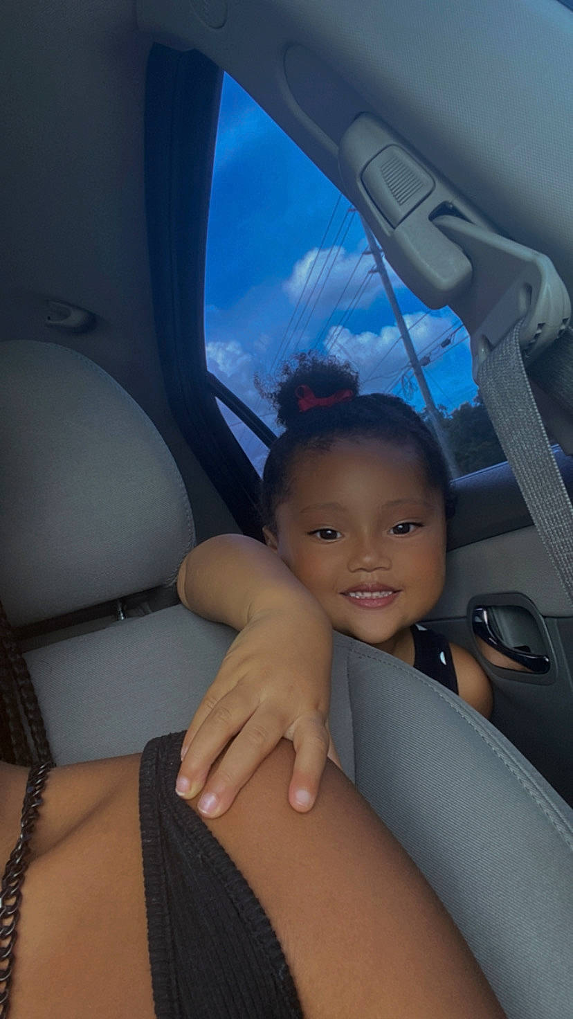 Zariyah joined the competition — help win amazing prizes! auto_part, automotive_design, automotive_exterior, azure, car_seat, car_seat_cover, cloud, comfort, electric_blue, finger, gesture, head_restraint, joy, mode_of_transport, motor_vehicle, person, sky, smile, thigh, thumb