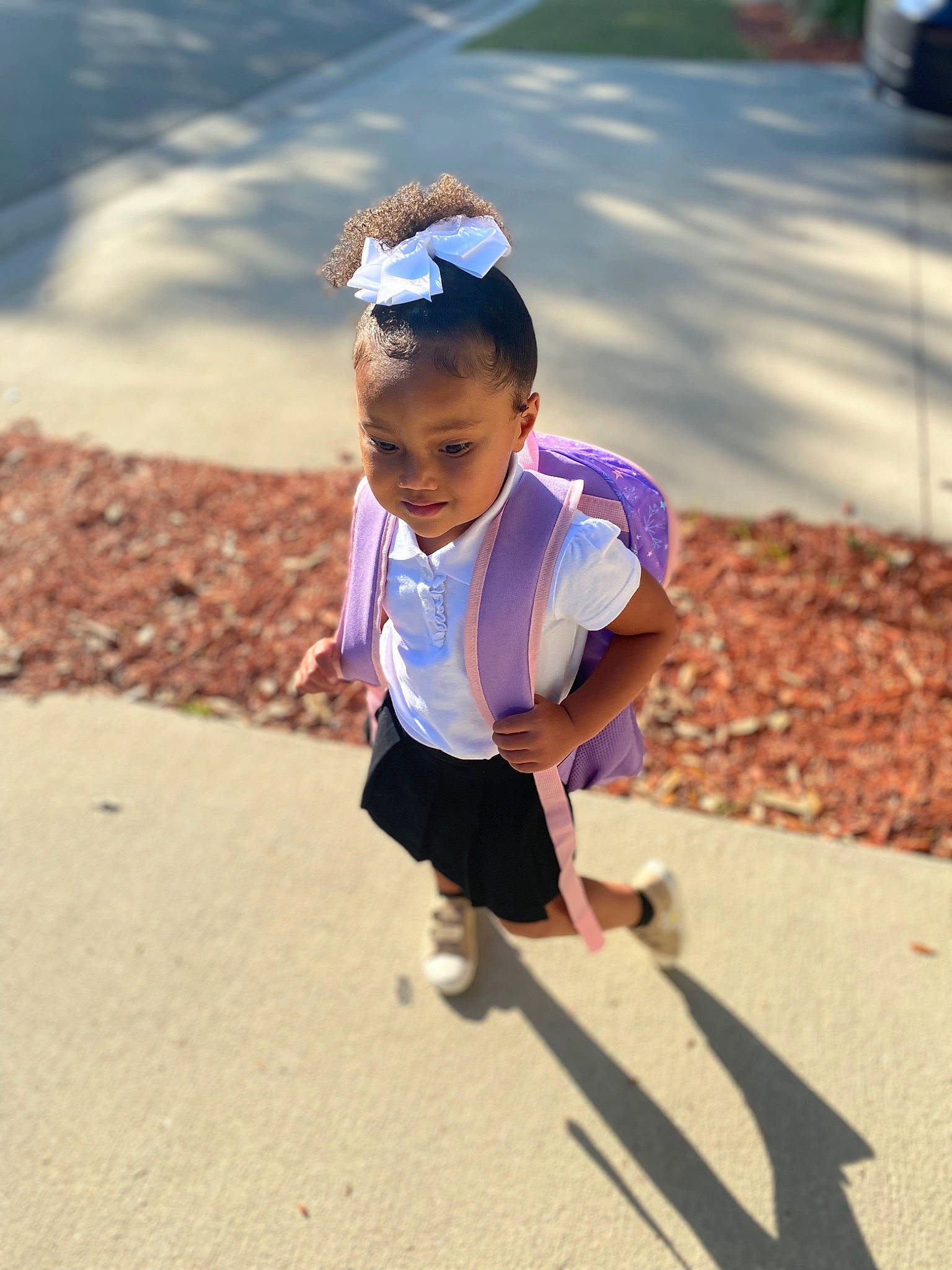 Zariyah joined the competition — help win amazing prizes! asphalt, child, city, electric_blue, eyewear, fun, grass, happy, head, leisure, people, person, public_space, recreation, road, sitting, smile, street, t_shirt, toddler