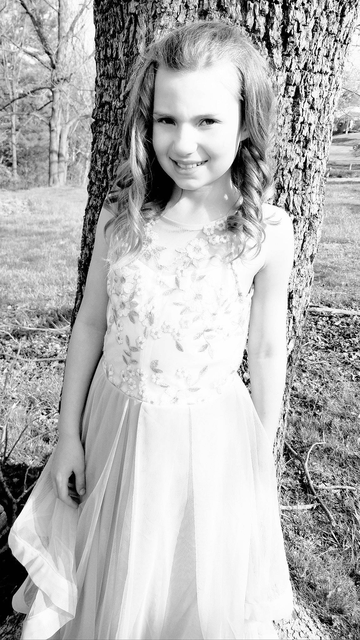 Isabella is registered to the contest to win money with this photo: black, black_and_white, dress, eye, face, fashion, flash_photography, hair, happy, head, joy, leaf, nature, people_in_nature, person, plant, skin, smile, standing, style