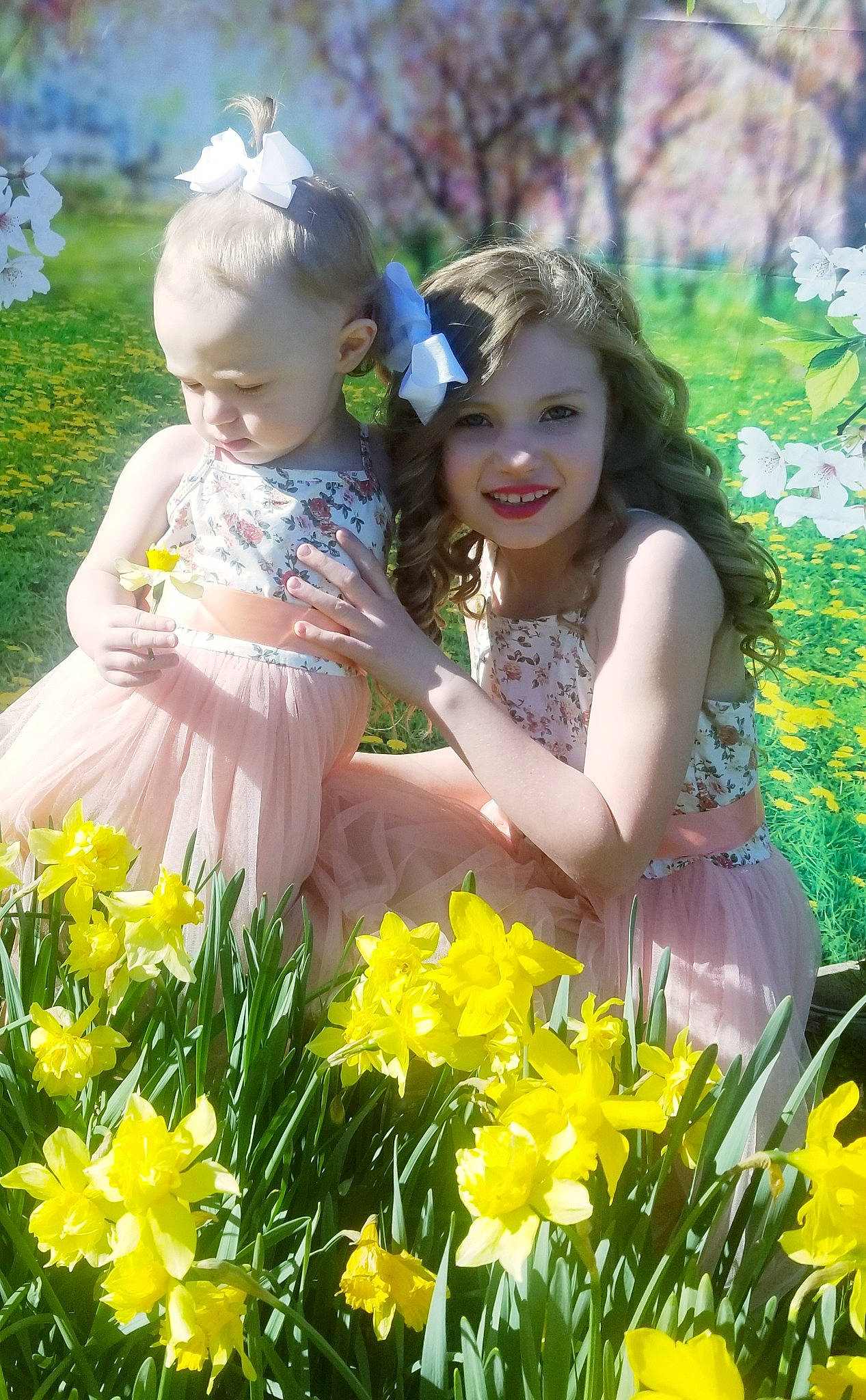 Isabella is registered to the contest to win money with this photo: baby_toddler_clothing, beauty, child, event, face, facial_expression, flower, fun, grass, happy, iris, joy, meadow, natural_environment, people_in_nature, person, petal, plant, sitting, smile