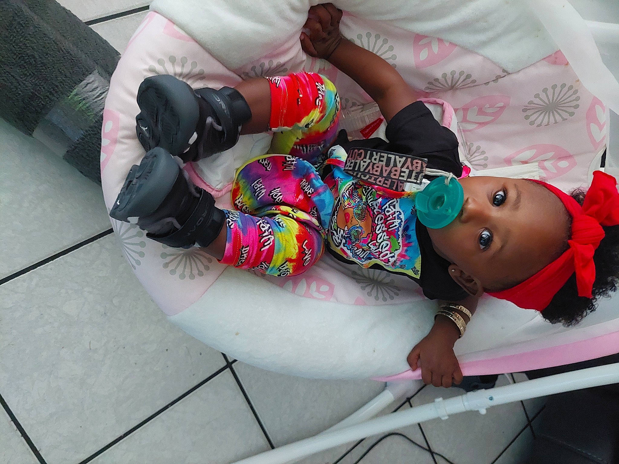 Ivory is registered to the contest to win money with this photo: baby, baby_products, baby_toddler_clothing, carmine, child, fun, glove, human_leg, knee, leisure, magenta, pattern, person, personal_protective_equipment, pink, recreation, room, sandal, thigh, toddler