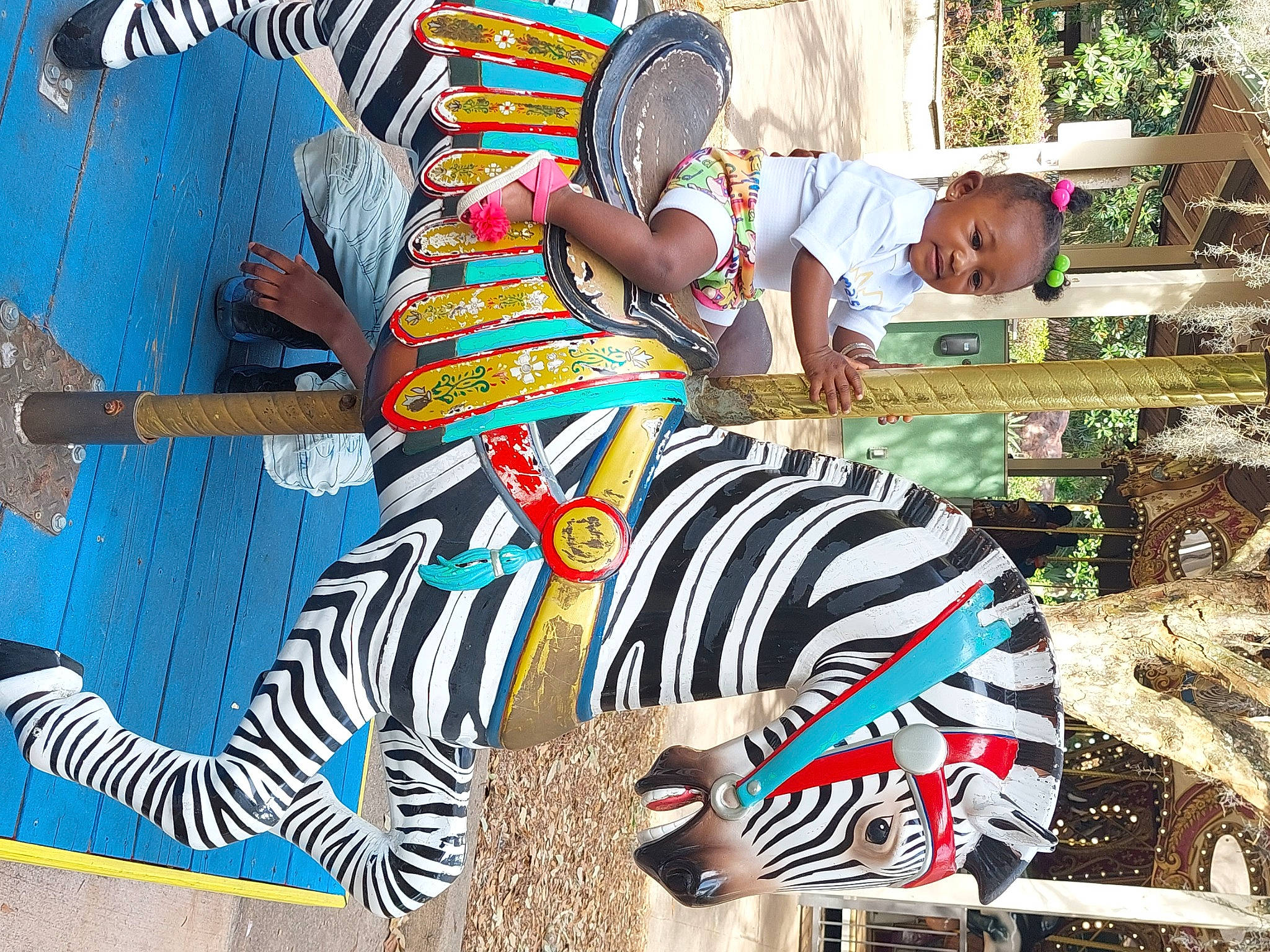 Ivory is registered to the contest to win money with this photo: art, artist, cool, event, eyewear, fun, grass, happy, hat, leisure, painting, pattern, person, plant, recreation, sitting, t_shirt, toddler, tree, visual_arts