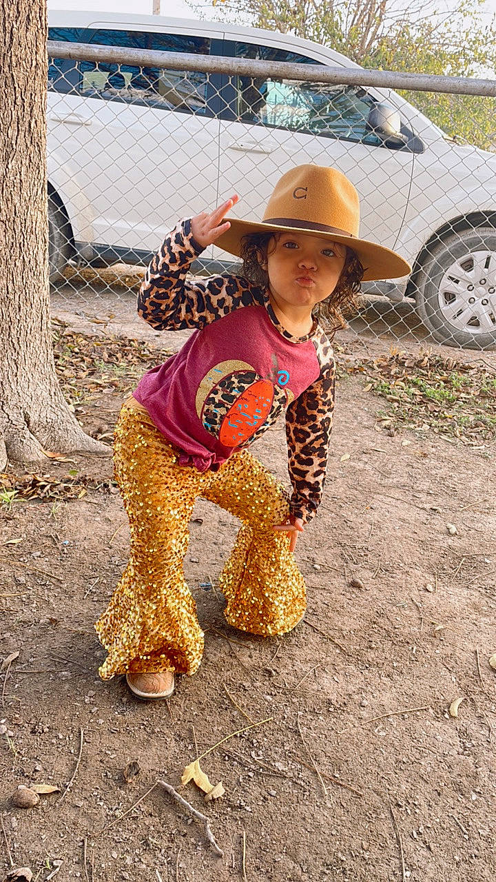 Kendra joined the competition — help win amazing prizes! automotive_tire, car, fashion_accessory, fun, grass, hat, head, headwear, landscape, leisure, motor_vehicle, person, personal_protective_equipment, soil, sun_hat, sunglasses, tire, toddler, tree, vehicle