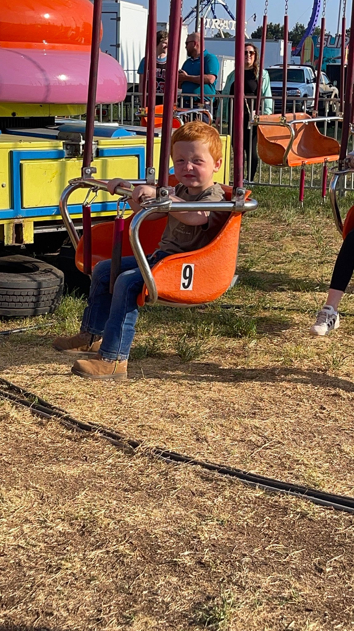 Cash is registered to the contest to win money with this photo: baby, child, chute, city, event, fun, grass, leisure, outdoor_play_equipment, person, play, playground, playground_slide, recreation, sitting, soil, swing, tire, toddler, tree