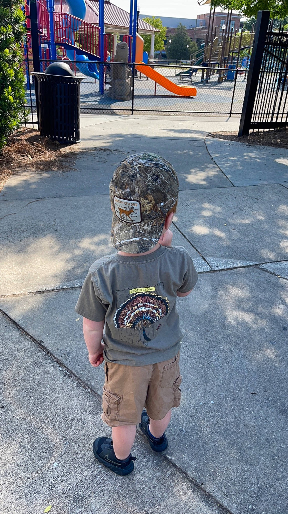 Cash is registered to the contest to win money with this photo: asphalt, blue, child, city, electric_blue, fun, headgear, metal, person, personal_protective_equipment, plant, recreation, road, road_surface, shorts, sidewalk, sleeve, sports_gear, sportswear, t_shirt