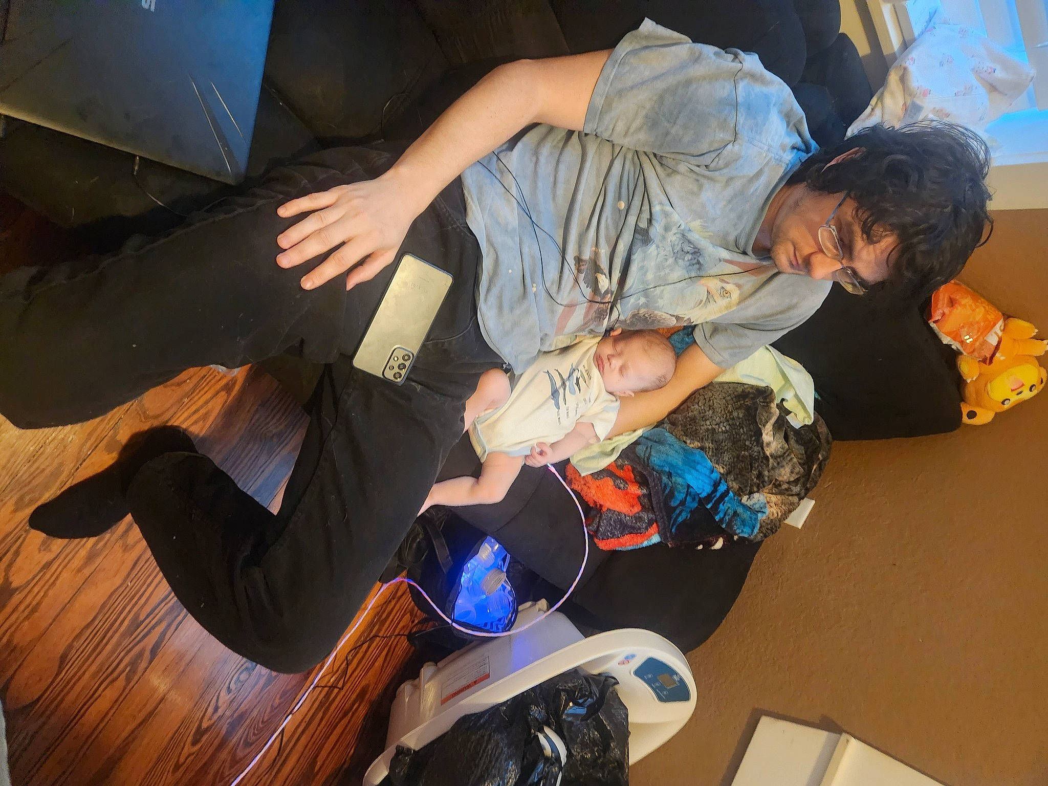 Austin is registered to the contest to win money with this photo: backpack, bag, boot, comfort, event, flooring, fun, hardwood, knee, lap, leg, leisure, luggage_and_bags, person, room, sandal, shoe, sitting, sneakers, thigh