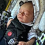 baby, bodypart, car, car_interior, carseat, clothing, cushion, face, finger, glove, hat, head, homedecor, newborn, person, photography, portrait, sleeping, transportation, vehicle