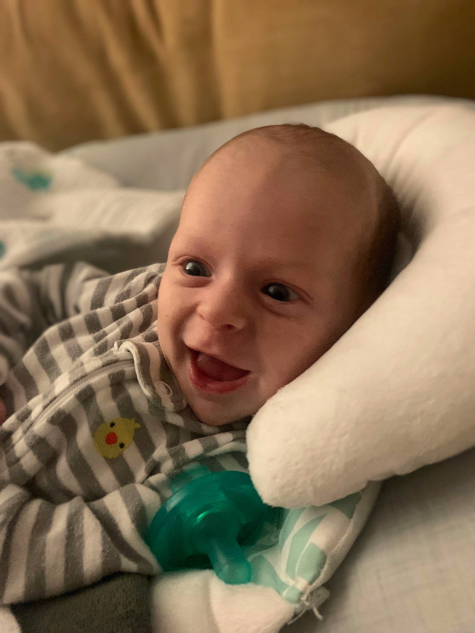 Wyatt is registered to the contest to win money with this photo: baby, baby_toddler_clothing, cheek, child, comfort, finger, gesture, happy, human_body, iris, linens, nose, pattern, person, plaid, sitting, skin, smile, tartan, textile