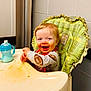 Hunter joined the competition — help win amazing prizes! toddler, high_chair, messy_face, smiling, food, sippy_cup, indoor, child, happy, plaid, clothing, feeding, baby, table, seat, person, cute, infant, meal_time, playful