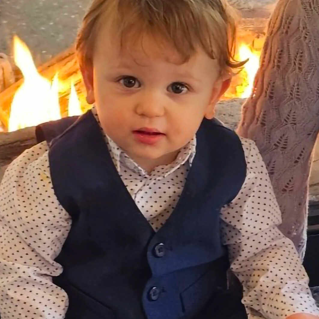 Rowan joined the competition — help win amazing prizes! baby, cheeks, child, clothing, cute, eyes, face, fire, fireplace, flames, formal_wear, hair, hands, indoor, lap, polka_dot_shirt, portrait, sitting, toddler, vest