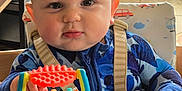 Rowan is registered to the contest to win money with this photo: accessories, baby, bodypart, car, couch, cutlery, face, finger, furniture, hand, head, indoors, person, photography, portrait, shelf, toy, transportation, vehicle, wood