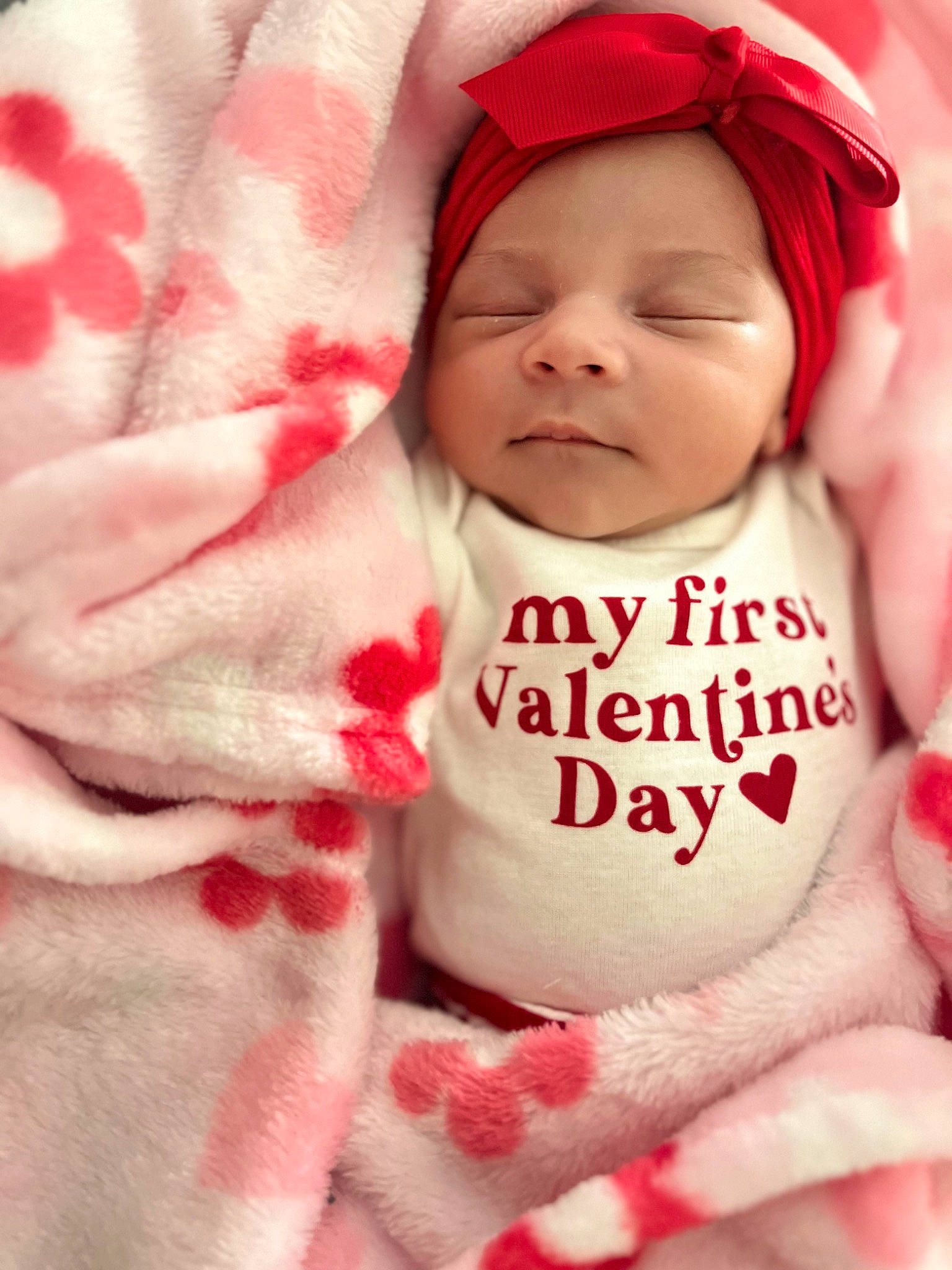 Zariah is registered to the contest to win money with this photo: baby, baby_toddler_clothing, cap, cheek, child, comfort, event, face, facial_expression, fur, happy, headwear, linens, lip, peach, person, pink, red, skin, textile