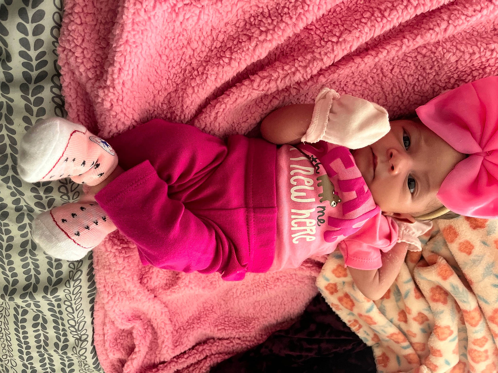 Zariah is registered to the contest to win money with this photo: arm, baby, baby_toddler_clothing, cheek, comfort, dress, finger, hand, headwear, human, human_body, lip, mammal, outerwear, person, pink, purple, skin, sleeve, textile