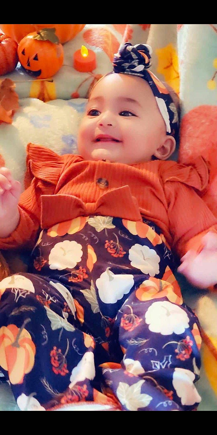 Rosalee is registered to the contest to win money with this photo: baby, baby_toddler_clothing, blue, cheek, eye, face, facial_expression, happy, head, iris, mouth, orange, people, person, pink, skin, smile, textile, toddler, white