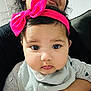baby, child, person, face, headband, pink_bow, bib, clothing, adult, holding, smile, portrait, indoor, cute, closeup, skin, expression, young, love, family