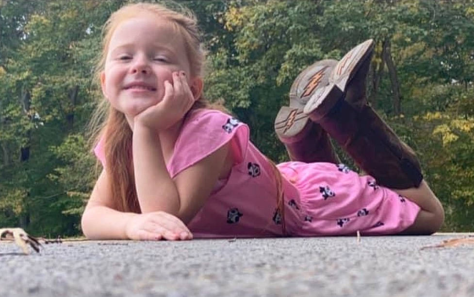 Cali is registered to the contest to win money with this photo: baseball_cap, cap, finger, fun, grass, happy, hat, joy, landscape, leisure, magenta, people_in_nature, person, pink, plant, recreation, smile, summer, sun_hat, travel