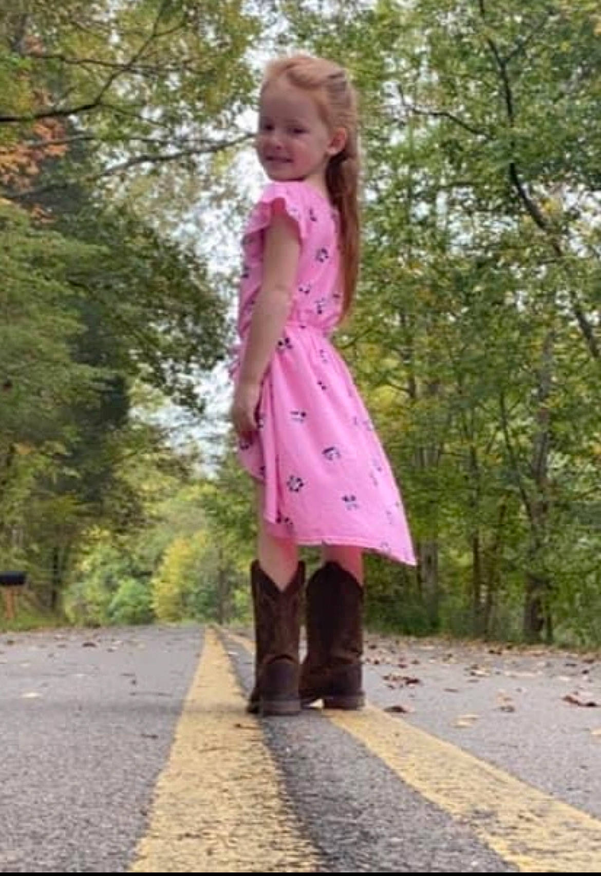 Cali is registered to the contest to win money with this photo: clothing, dress, fashion_design, grass, hair, human_leg, knee, long_hair, magenta, pattern, people_in_nature, person, pink, plant, road_surface, sleeve, tints_and_shades, toddler, tree, waist