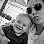 baby, black_and_white, casual, child, clothing, cute, face, family, happy, head, holding, joyful, outdoor, person, portrait, smile, sunglasses, together, umbrella, woman