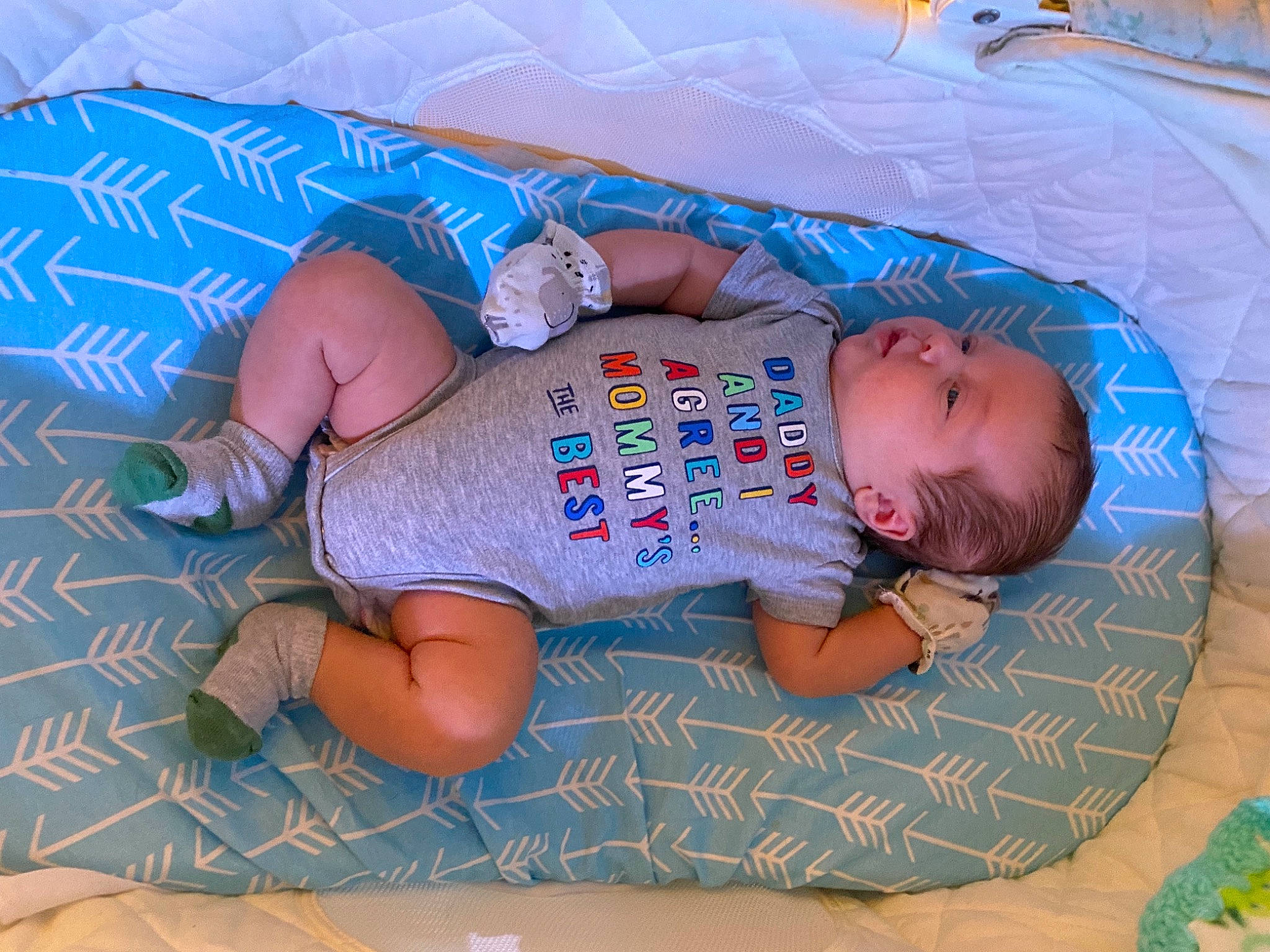 Beau is registered to the contest to win money with this photo: baby, baby_products, baby_toddler_clothing, blue, child, comfort, finger, fun, grass, hand, human_body, lap, leg, leisure, mouth, pattern, person, skin, textile, thigh