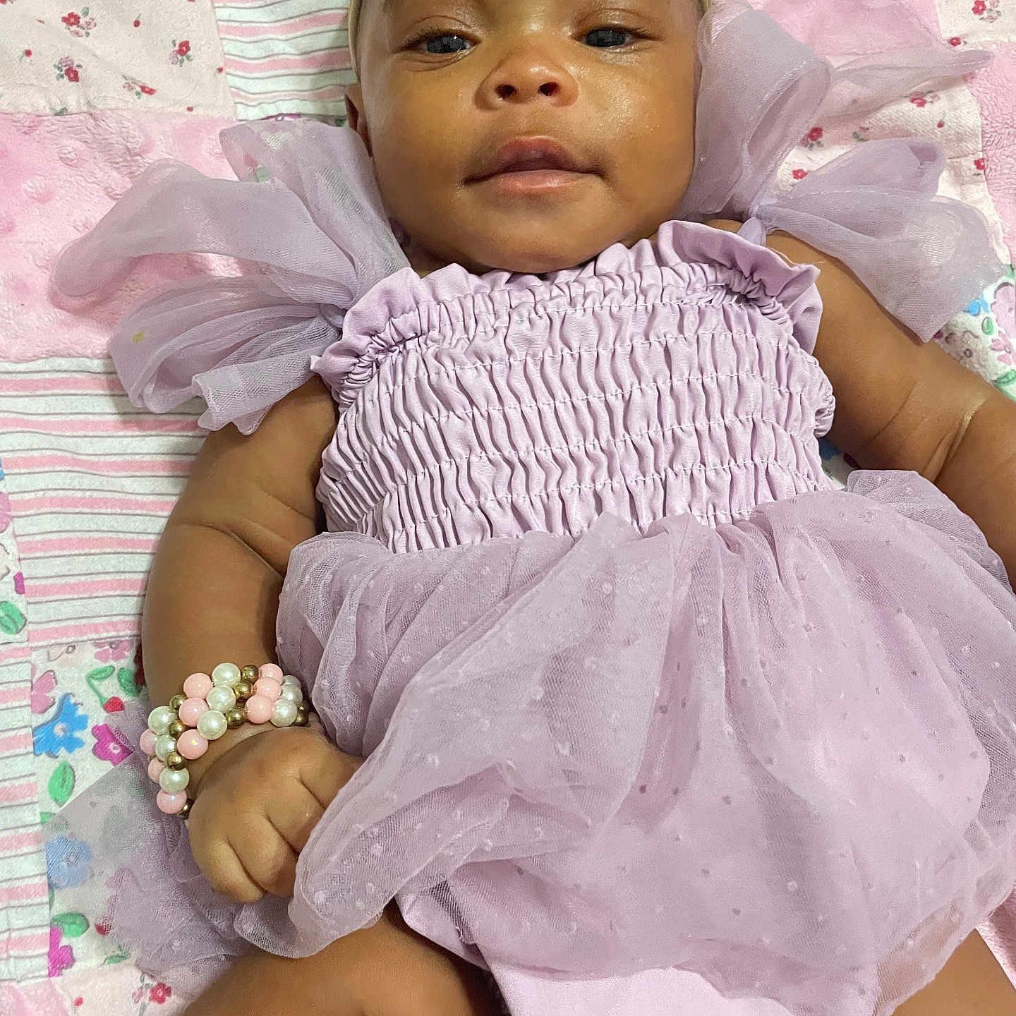 Rivyr-Bleu is registered to the contest to win money with this photo: accessories, baby, bonnet, bracelet, clothing, dress, face, flower, happy, hat, head, jewelry, necklace, newborn, person, photography, portrait, sitting, sleeve, smile