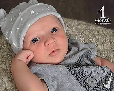 Xavier joined the competition — help win amazing prizes! baby, baby_products, baby_toddler_clothing, beanie, cap, cheek, child, eye, face, fashion_accessory, flash_photography, fun, grass, happy, headwear, lip, nose, person, sitting, skin